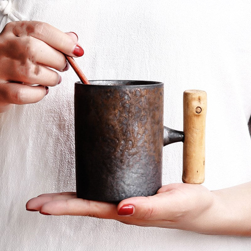 Handmade coarse pottery mug with spoon