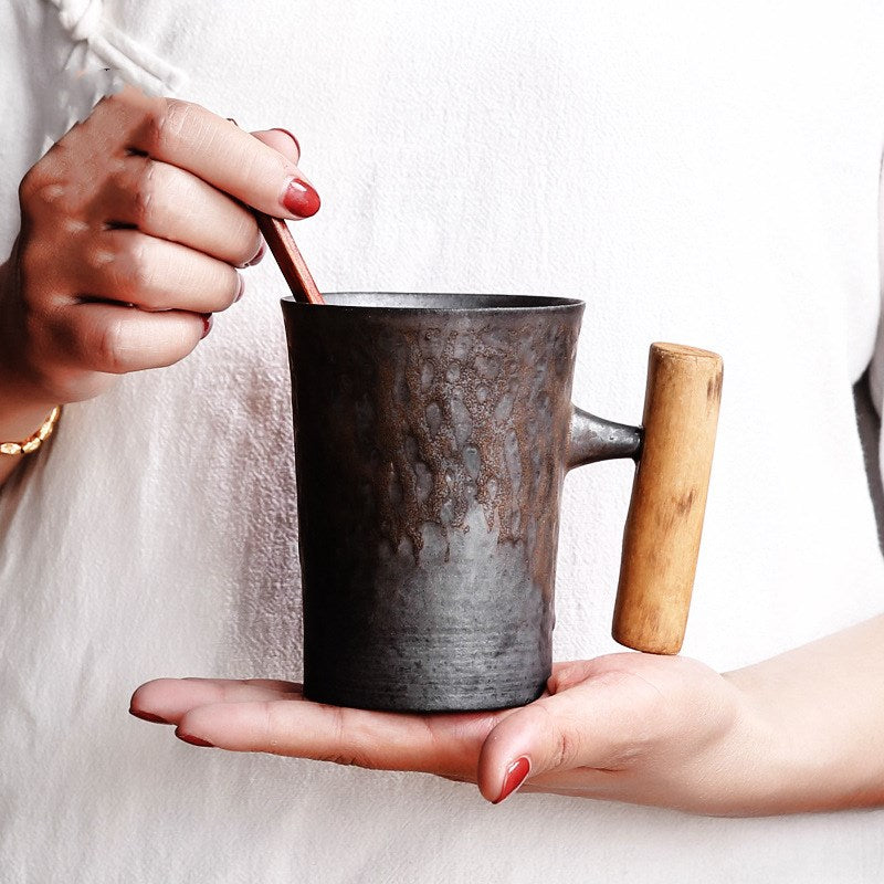 Handmade coarse pottery mug with spoon