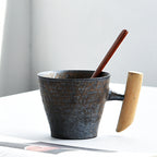 Handmade coarse pottery mug with spoon