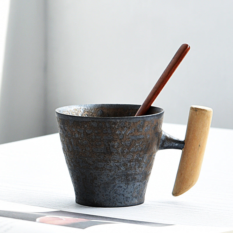 Handmade coarse pottery mug with spoon
