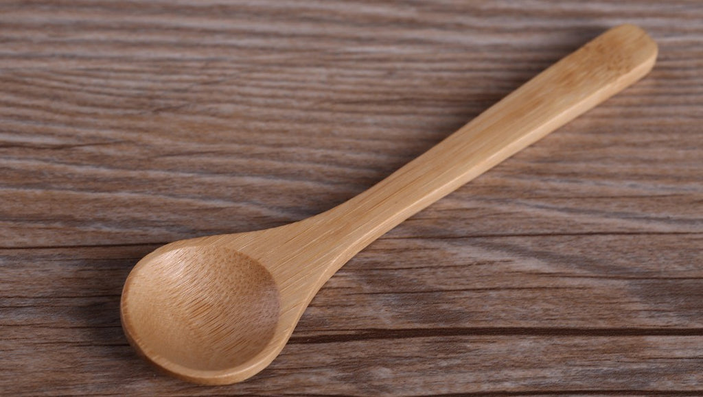 Handmade coarse pottery mug with spoon